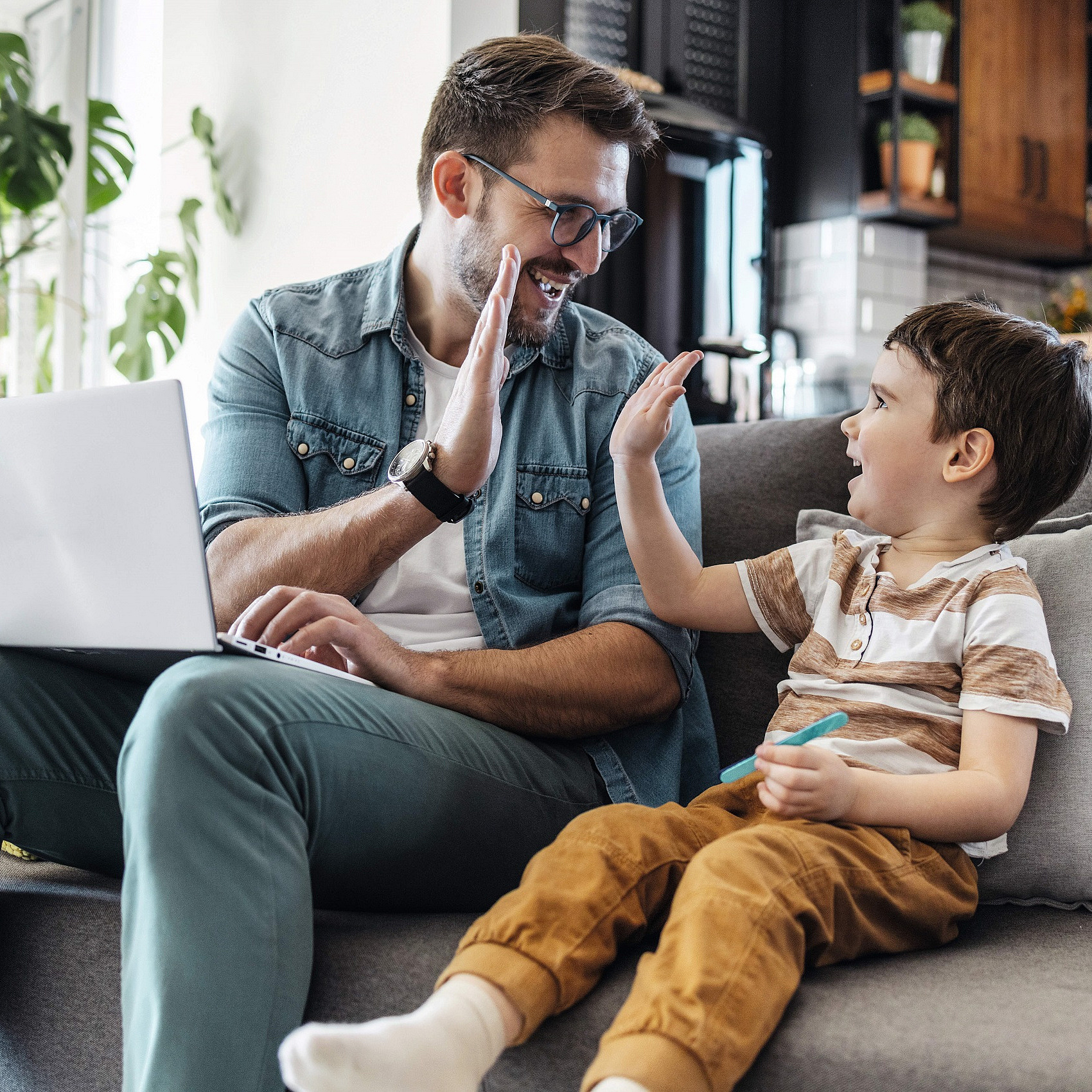 Vater und Sohn sitzen auf dem Sofa