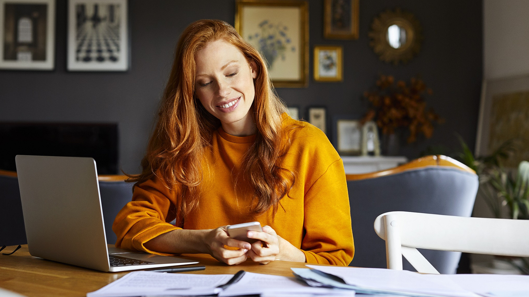 Eine Frau an ihrem Homeoffice-Schreibtisch, den Laptop aufgeklappt